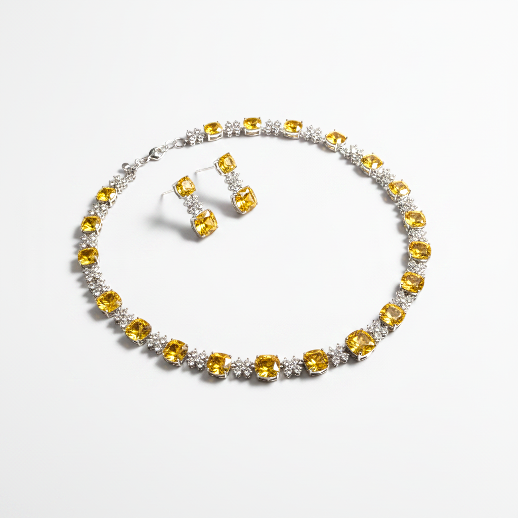 Jewelry set with yellow gemstones on a white background