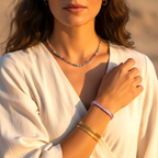 Woman wearing a colorful beaded necklace and bracelets on a blurred natural background
