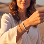 Woman wearing two bracelets on her wrist with a blurred natural background