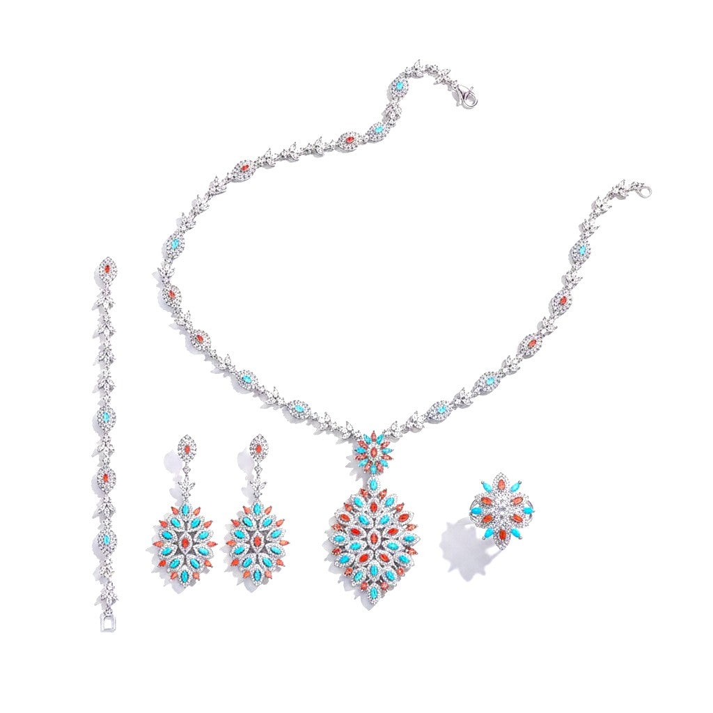 The Accessory Bar Alya bridal jewelry set featuring a necklace, earrings, bracelet, and ring with turquoise and coral stones.