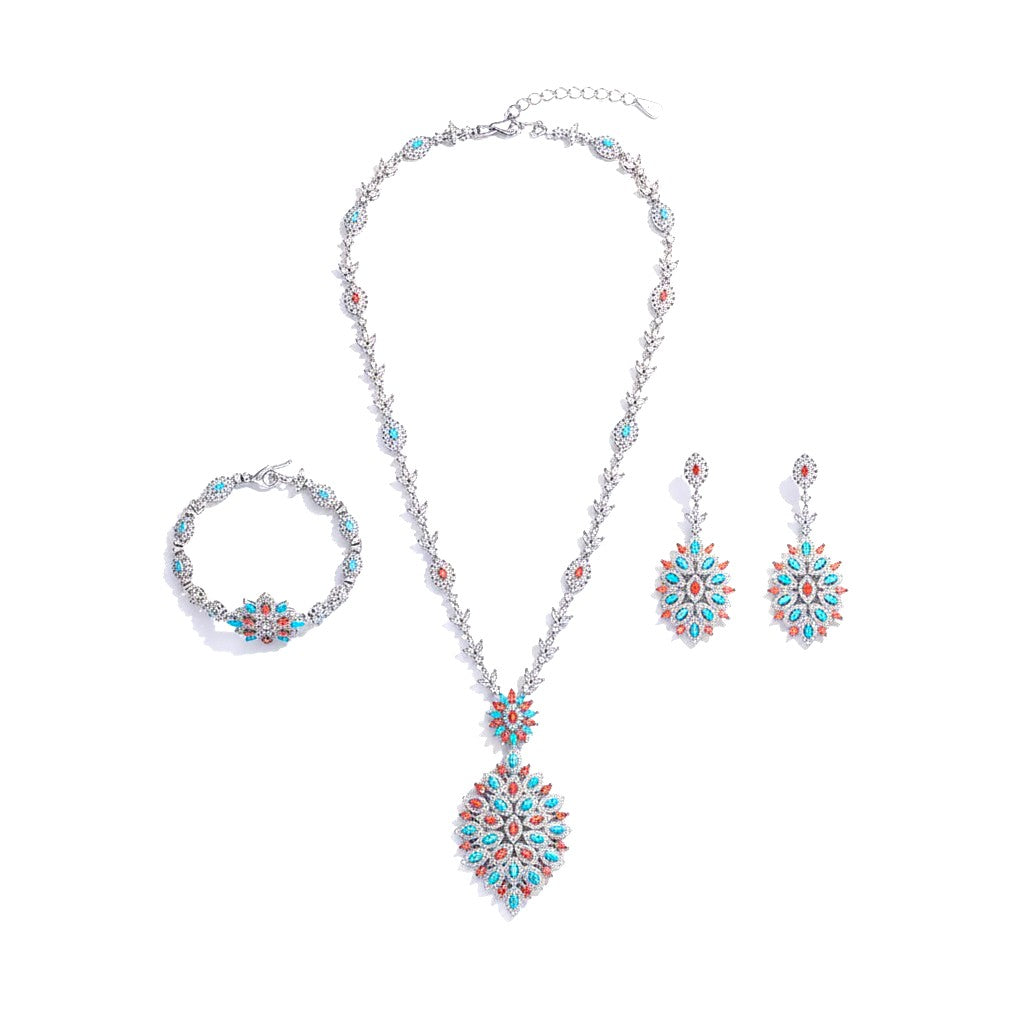 The Accessory Bar Alya bridal jewelry set featuring a necklace, earrings, and bracelet with turquoise and coral stones.