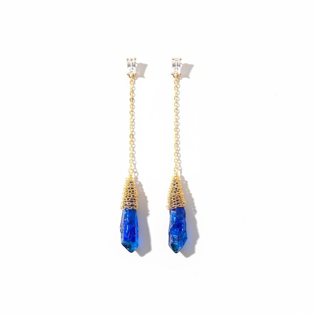 The Accessory Bar gold-plated chain drop earrings featuring blue crystal pendants and clear cubic zirconia accents.