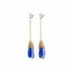 The Accessory Bar gold-plated chain drop earrings featuring blue crystal pendants and clear cubic zirconia accents.
