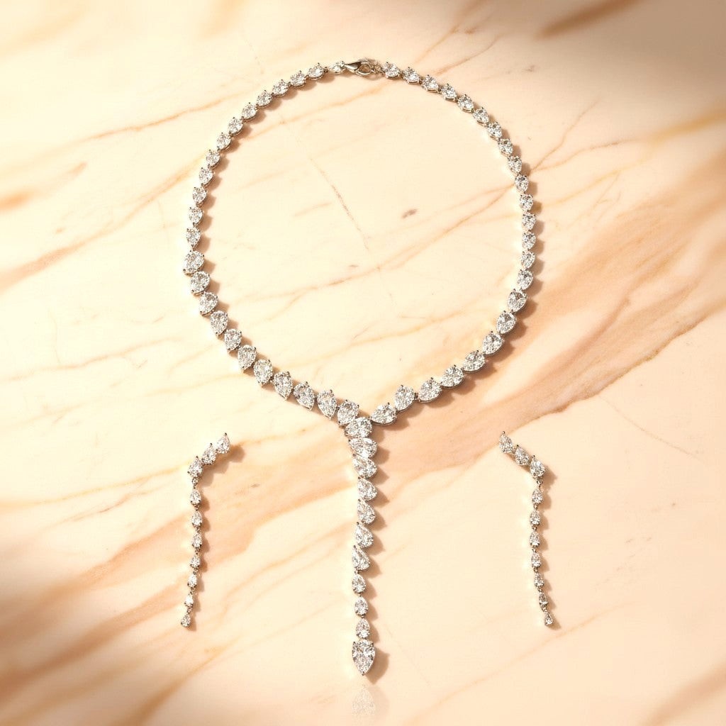 The Accessory Bar Doha set featuring a silver-tone necklace and matching drop earrings with clear pear-cut crystals.