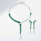The Accessory Bar Doha set featuring a silver-tone necklace and drop earrings with pear-cut emerald cubic zirconia.