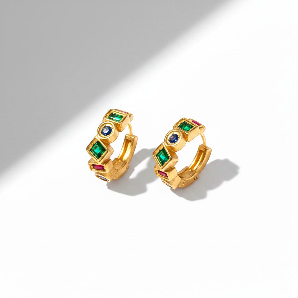 The Accessory Bar gold-plated C-hoop earrings featuring multi-coloured cubic zirconia stones in a geometric design.