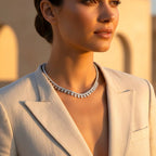 The Accessory Bar Hessa heart-detail tennis choker in icy white with cubic zirconia worn by a woman in a blazer.