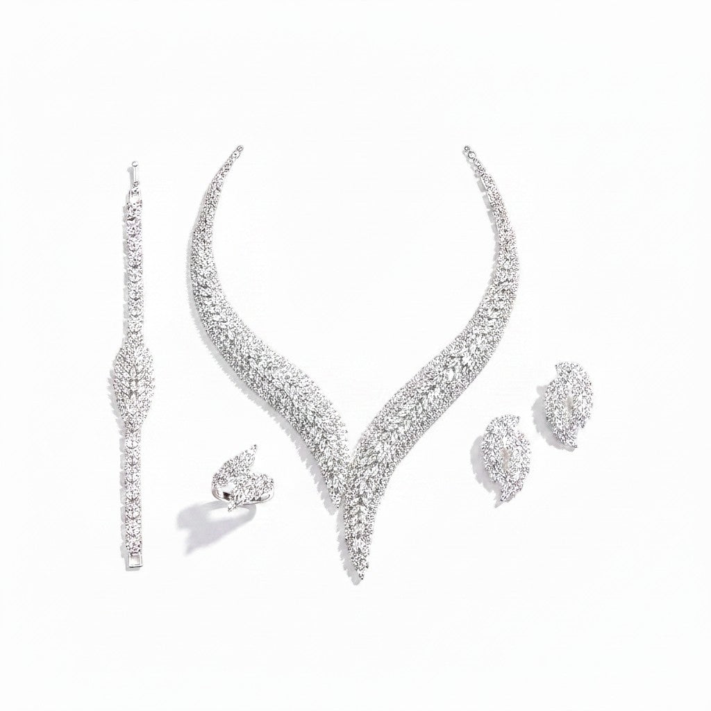 The Accessory Bar Layla bridal jewelry set featuring a rhodium-plated necklace, earrings, ring, and tennis bracelet.
