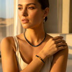 Model wearing The Accessory Bar Leila set featuring a silver-tone tennis necklace, bracelet, and stud earrings.