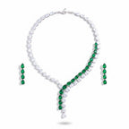 The Accessory Bar Nadia set featuring a silver-tone tennis necklace and matching earrings with emerald green stones.