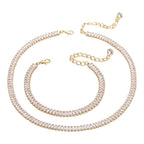 The Accessory Bar Riva set featuring a gold-plated tennis necklace and matching bracelet with clear cubic zirconia.