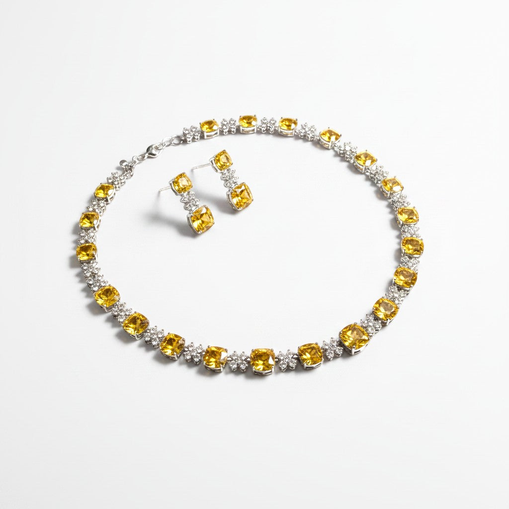 The Accessory Bar Sahara set featuring a citrine yellow cushion CZ necklace and matching drop earrings in gold-plated.