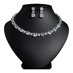 The Accessory Bar Sahara Set featuring a choker necklace and drop earrings with clear cushion-cut cubic zirconia stones.